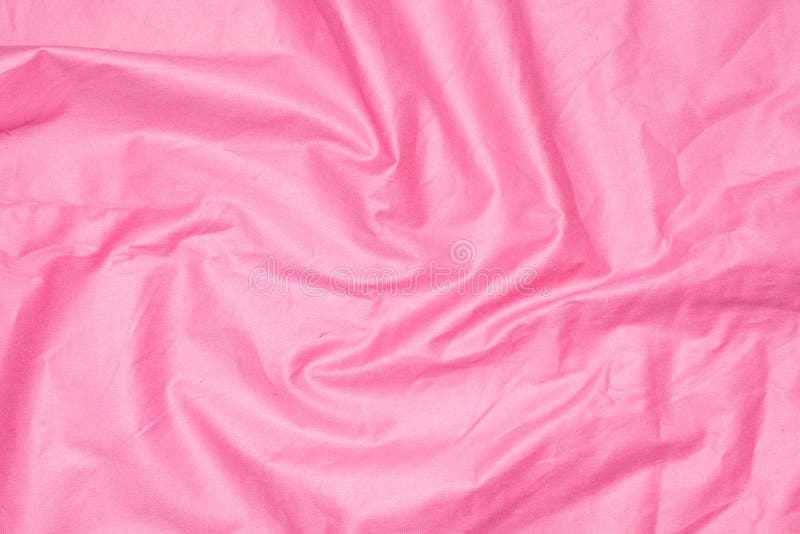 Crinkled pink material texture or background