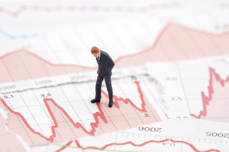 Figure of businessman on financial charts. Figure of businessman on financial charts