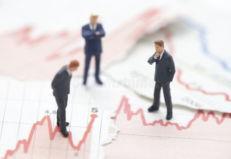 Financial crisis. Figures of businessman on financial charts. Financial crisis. Figures of businessman on financial charts