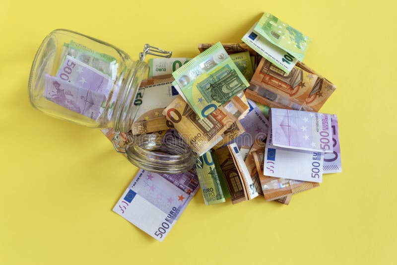 Crisis and budget deficit concept. Money and empty glass money jar. Euro banknotes, money box. Income, savings stock photo Crisis and budget deficit concept. Money and empty glass money jar. Euro banknotes, money box. Income, savings stock photo