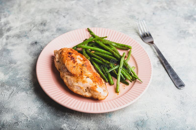 Crispy Chicken Breast Served with Green Beans on Plate Stock Image