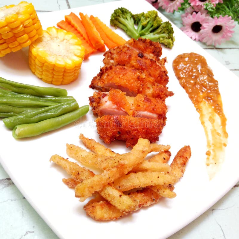 Crispy Chicken Steak with Barbeque Sauce, Vegetables and Potatoes Stock