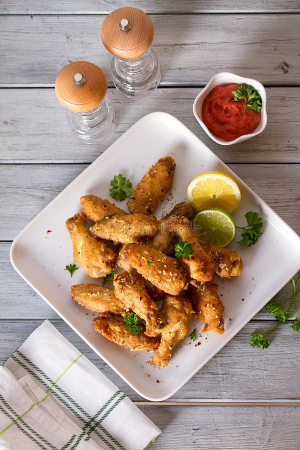 Crispy Chicken Wings with Lemon and Sauce. Stock Photo Image of sauce