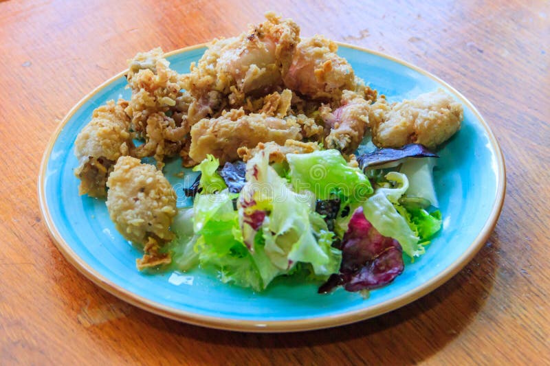 Crispy Deep Fried Baby Octopus Served with Salad on Wooden Table Stock Photo Image of octopus