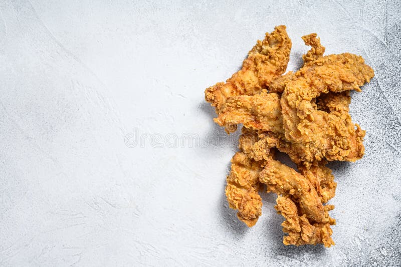 Crispy Fried Breaded Chicken Breast Strips. White Background. Top View