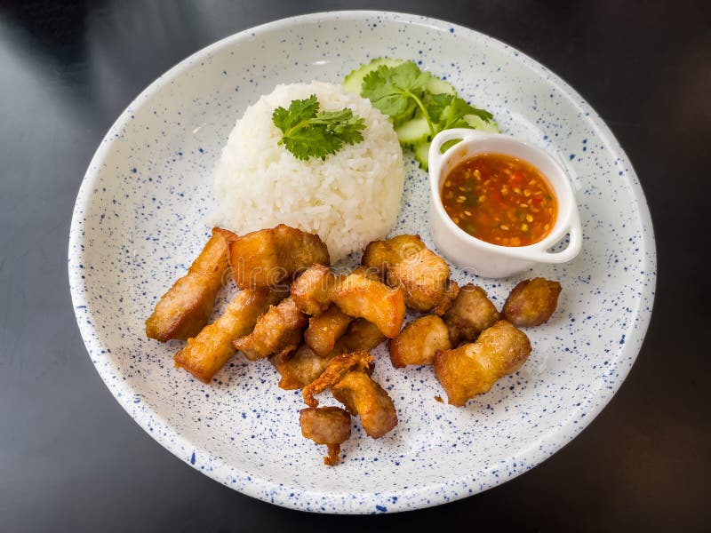Crispy Fried Pork on Rice with Fish Sauce and Coriander Cucumbers and