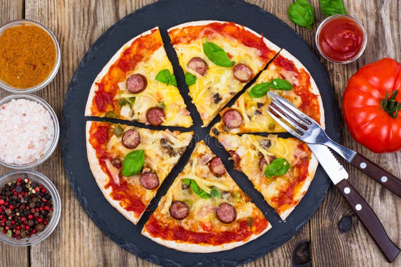 Crispy hot pizza on old wooden table royalty free stock photography