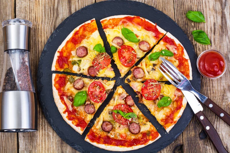 Crispy hot pizza on old wooden table stock image