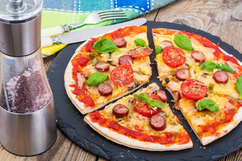 Crispy hot pizza on old wooden table royalty free stock photos