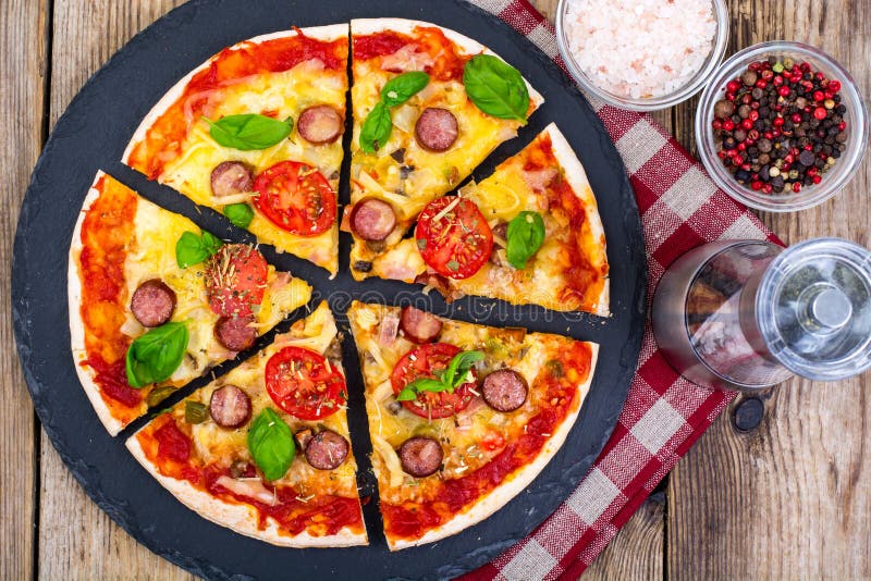 Crispy hot pizza on old wooden table stock photos