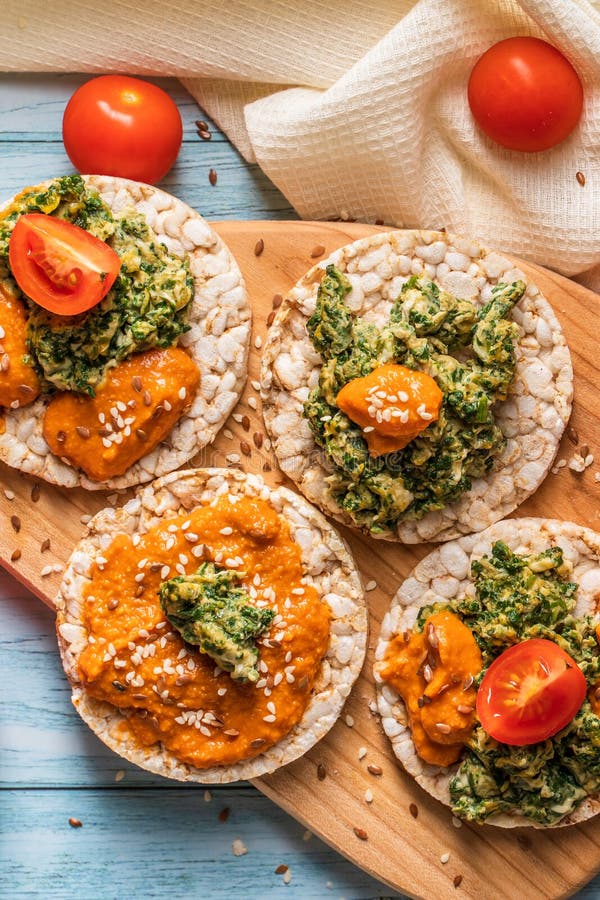 Crispy Puffed Rice Cakes on Table with Hummus Spread Spinach with Eggs