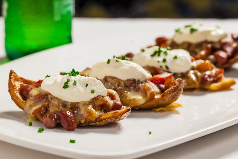 Crispy skin potatoes with kidney bean & tomato salsa with sour cream and chives. Crispy skin potatoes with kidney bean & tomato salsa with sour cream and chives