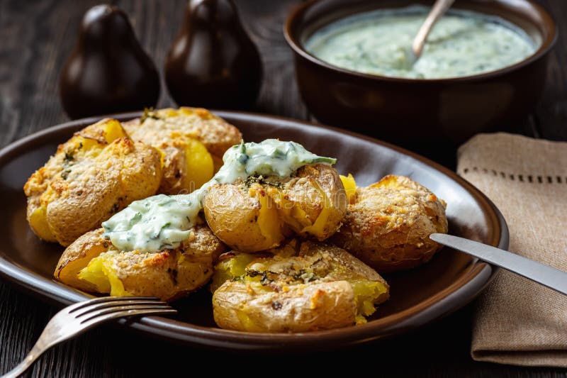 Crispy smashed potatoes roasted with garlic and parmesan. stock photo