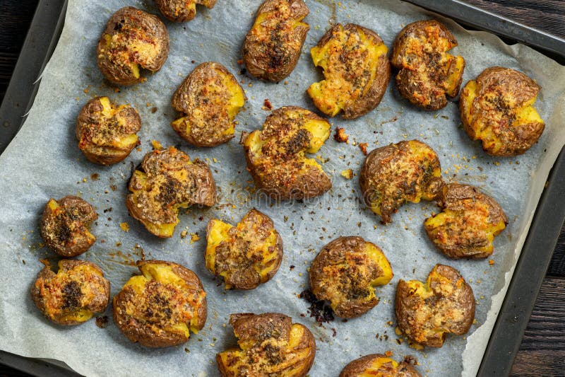 Crispy smashed potatoes roasted with garlic and parmesan. stock image