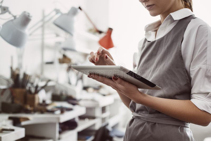 CRM system. The main female production manager working online with her digital tablet royalty free stock photography CRM system. The main female production manager working online with her digital tablet royalty free stock photography