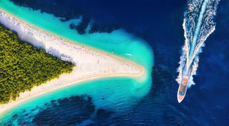 Croatia, Hvar island, Bol. Aerial view at the Zlatni Rat. Aerial view of luxury floating boat on blue Adriatic sea at sunny day.