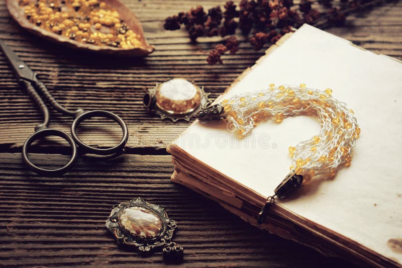 Crochet bracelet making with yellow beads and yarn on a wooden table â€“ DIY handmade jewelry project, needlework tutorial stock photo