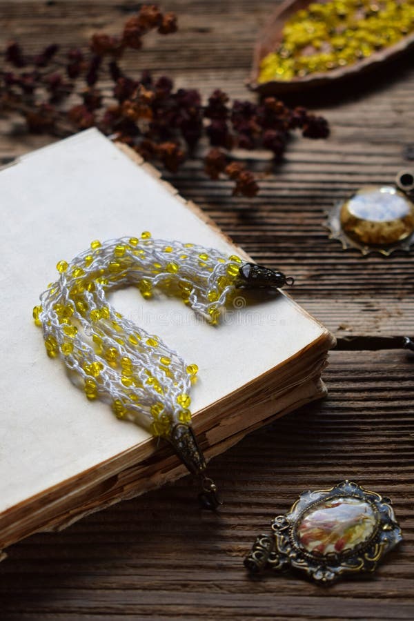Crochet bracelet making with yellow beads and yarn on a wooden table â€“ DIY handmade jewelry project, needlework tutorial stock photos