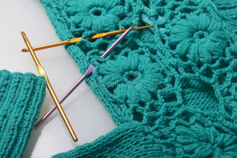 Crochet Hooks are Stuck in the Finished Knitted Product. Stock Photo