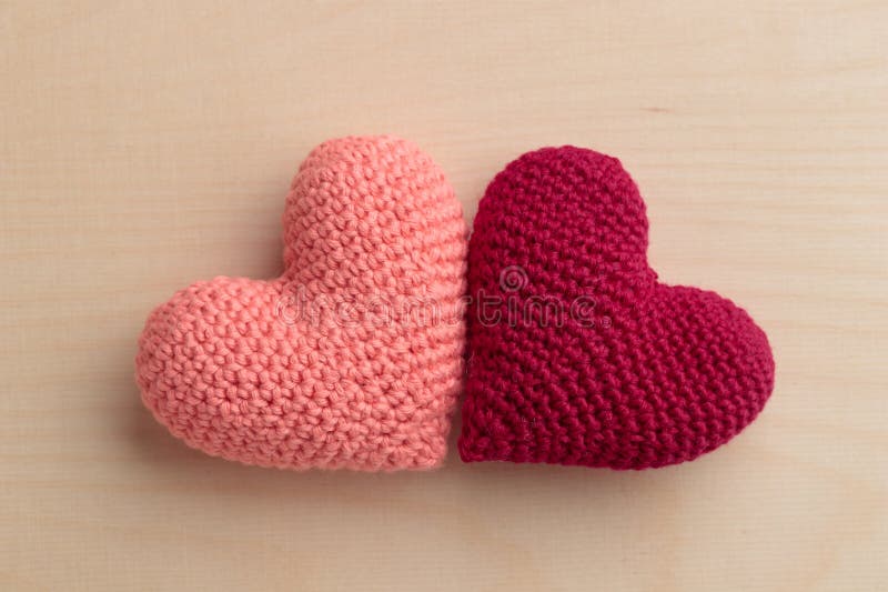 Premium Photo  Knitted heart of pink thread with crochet hooks