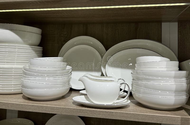Crockery Plates on the Shelf. Cutlery for the Kitchen or Restaurant