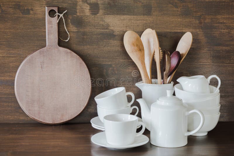 Set of kitchen ceramic tableware and wooden cutting boards on a table. Eco  style home still life. Stock Photo by Edalin