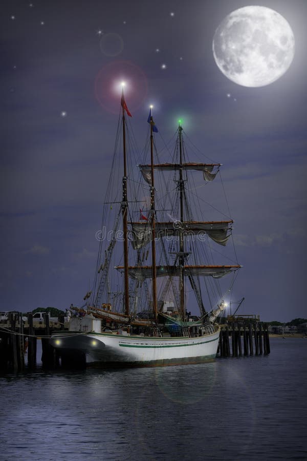 Sail boat at dock getting ready for a night time sail. Full moon, stars, and lights on boat shine bright. Sail boat at dock getting ready for a night time sail. Full moon, stars, and lights on boat shine bright.