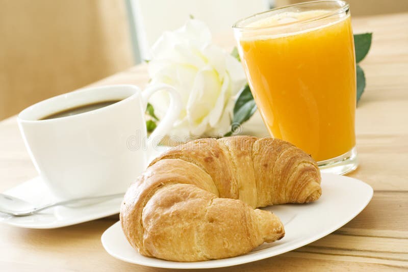 Croissant, coffee and fruit juice at breakfast. Croissant, coffee and fruit juice at breakfast