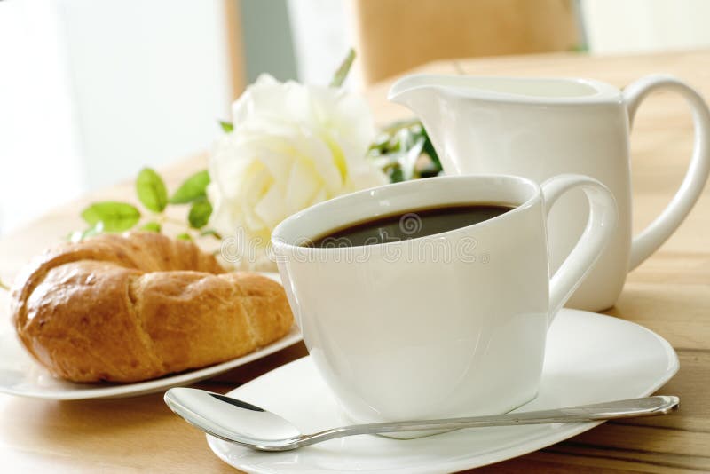 Fresh-baked croissant and coffee at breakfast. Fresh-baked croissant and coffee at breakfast