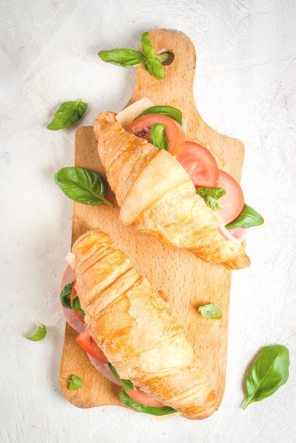 Croissant with Ham, Cheese, Fresh Tomatoes and Basil Stock Image