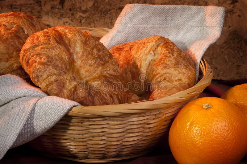 Croissant served for breakfast orange fruit