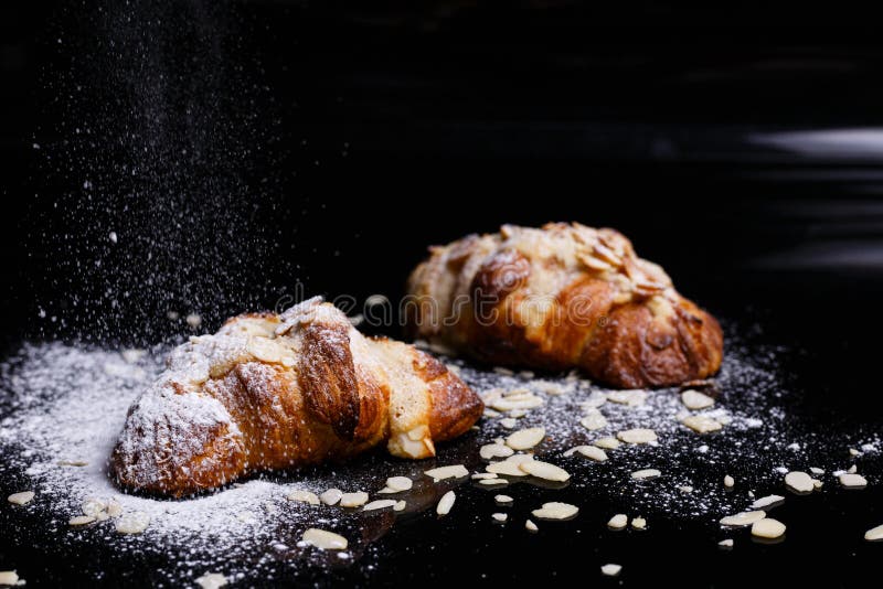 Croissants with chocolate. Homemade pastries, croissants sprinkled with powder and cereals.