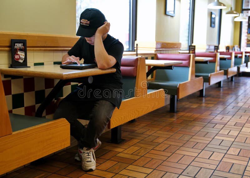 Fast food employee taking a break at table