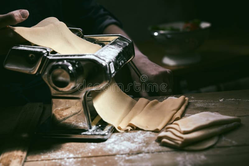 Crop Chef Using Pasta Machine for Rolling Dough Stock Photo - Image of