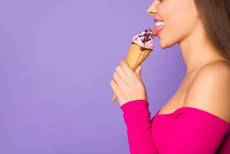 Cropped closeup photo of funny lady stick tongue out mouth lick delicious, vanilla ice cream wear pink off-shoulders cropped top isolated pastel purple color background. Cropped closeup photo of funny lady stick tongue out mouth lick delicious, vanilla ice cream wear pink off-shoulders cropped top isolated pastel purple color background