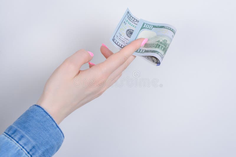 Cropped closeup side profile photo portrait of hands holding showing one hundred dollars isolated over grey background.