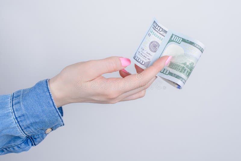 Cropped closeup side profile photo portrait of hands holding showing one hundred dollars isolated over grey background.