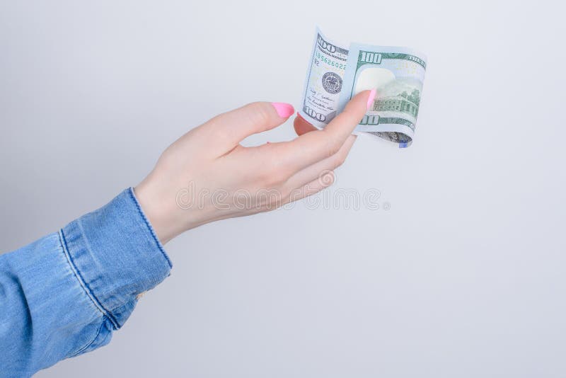 Cropped closeup side profile photo portrait of hands holding showing one hundred dollars  over grey background.