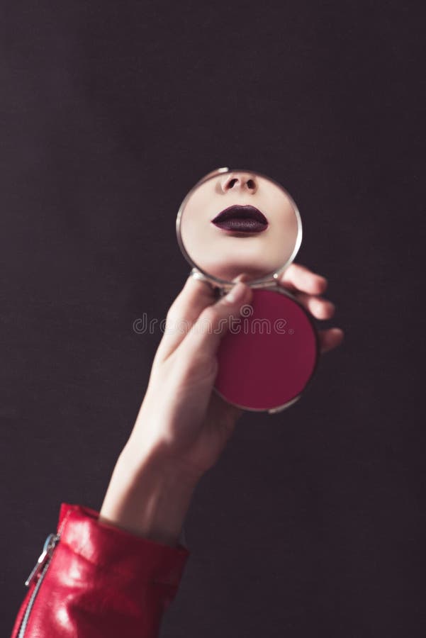 cropped image of attractive girl with dark lips looking at mirror stock photo cropped image of attractive girl with dark lips looking at mirror stock photo
