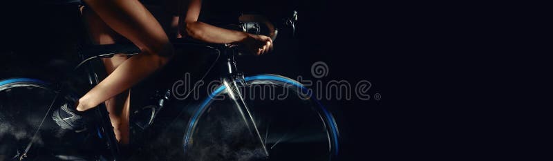 Cropped image bicycle wheels motion digital art effect body part slim legs of woman riding on bicycle aside, studio shot