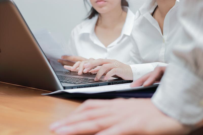 Cropped image of hands of young Asian business people working together on a laptop computer at office. Teamwork brainstroming conc stock images Cropped image of hands of young Asian business people working together on a laptop computer at office. Teamwork brainstroming conc stock images