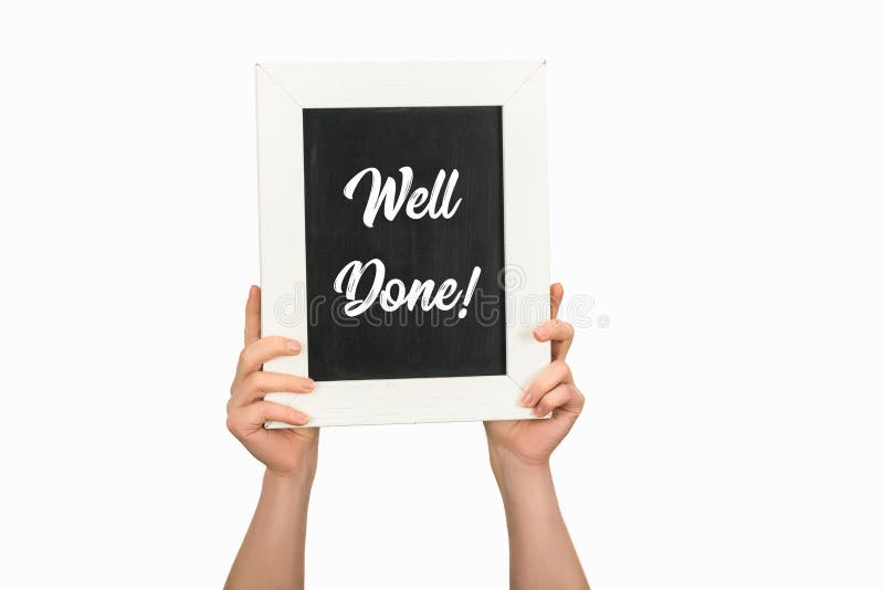 Cropped image of woman hands holding board with lettering well done on white stock photography