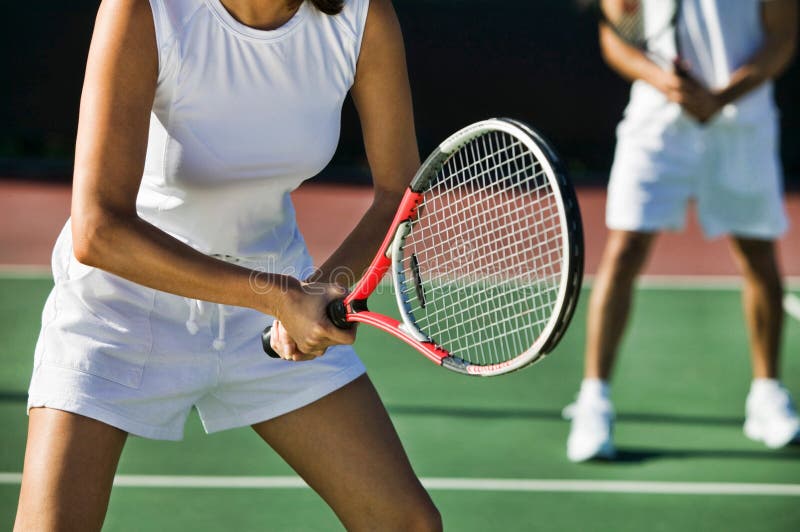 Cropped photo of tennis players playing on court