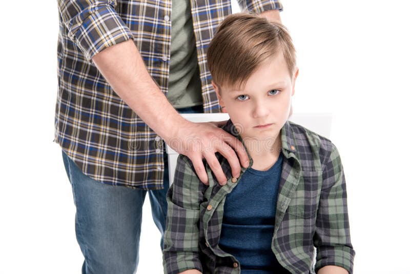 Cropped shot of father putting hand on shoulder of upset little son, family problems concept