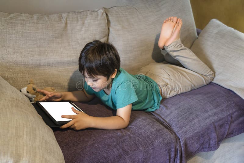 Cropped Shot Kid Lying on Sofa Watching Cartoons on Tablet,6-7 Year Old Boy  Playing Game on Touch Pad, Children Having Activity on Stock Photo - Image  of caucasian, looking: 194600408