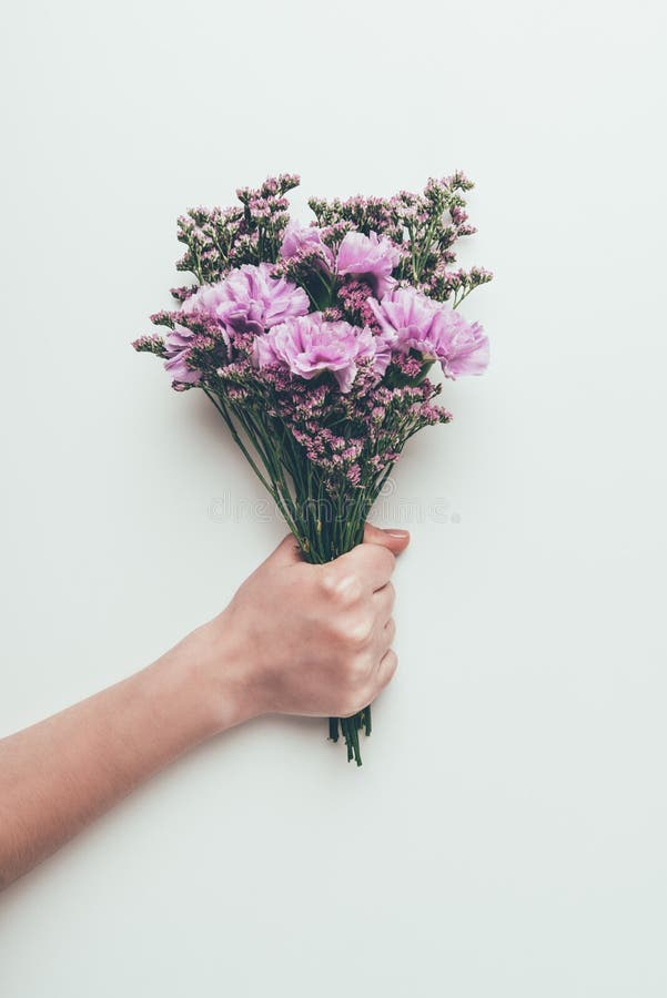 Cropped shot of person holding beautiful elegant bouquet of tender flowers