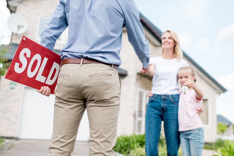 cropped shot of realtor with sold sign shaking hand of young woman royalty free stock images cropped shot of realtor with sold sign shaking hand of young woman royalty free stock images