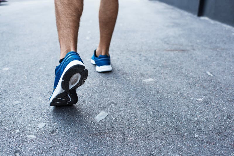 Cropped shot of sportsman in jogging sneakers royalty free stock photography Cropped shot of sportsman in jogging sneakers royalty free stock photography