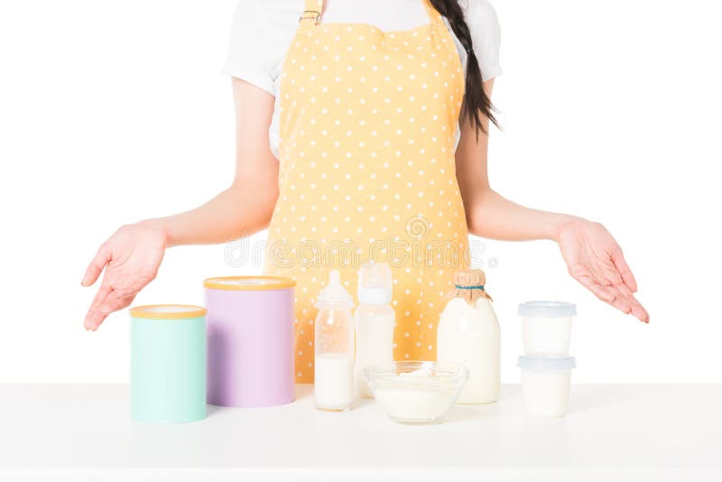 cropped shot of woman in apron with wide arms standing at table with children food and milk stock photography cropped shot of woman in apron with wide arms standing at table with children food and milk stock photography