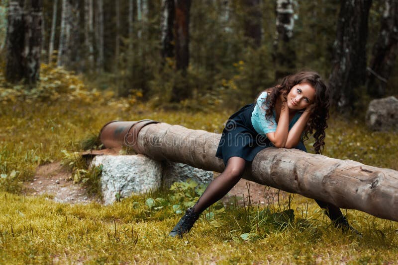 Cropped view of beautiful young woman walking in forest stock image